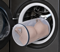 HugMyBody Mesh Laundry Bag with a zippered closure, containing a Brown HugMyBody™ Signature Jelly Bra and shown inside an open front-loading washing machine.